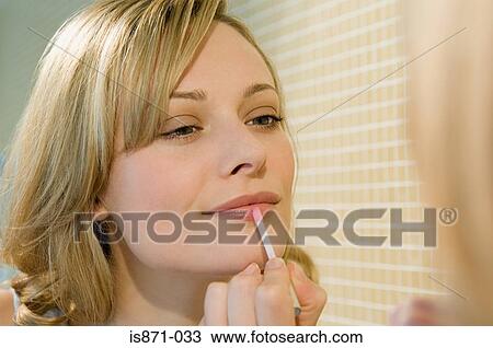 Woman using lipgloss View Large Photo Image Stock Image - Woman using lipgloss. Fotosearch