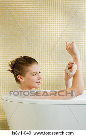 Woman using massage brush View Large Photo Image Stock Photo - Woman using massage brush. Fotosearch