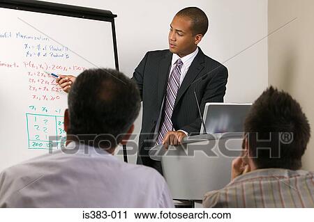 Stock Image - Businessman giving presentation. Fotosearch