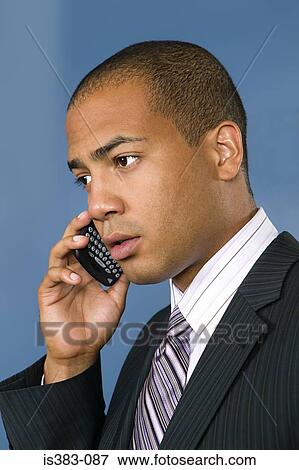 Businessman using cell phone View Large Photo Image Stock Photo - Businessman using cell phone. Fotosearch