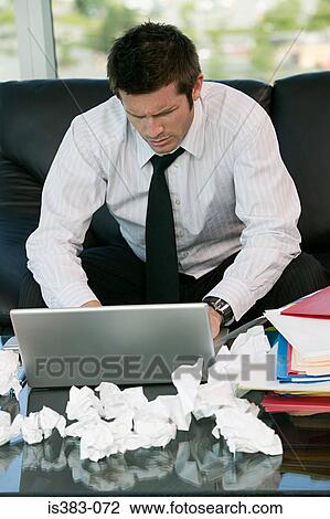 Stock Image - Businessman using laptop. Fotosearch