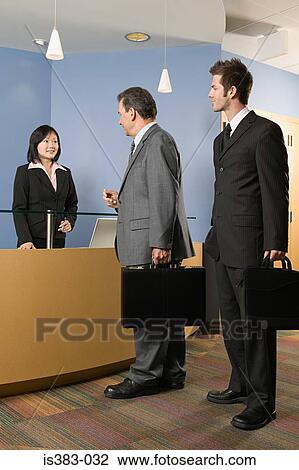 Businessmen at a reception desk View Large Photo Image Stock Image - Businessmen at a reception desk. Fotosearch