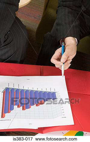 Businesspeople with a bar graph View Large Photo Image Stock Photo - Businesspeople with a bar graph. Fotosearch