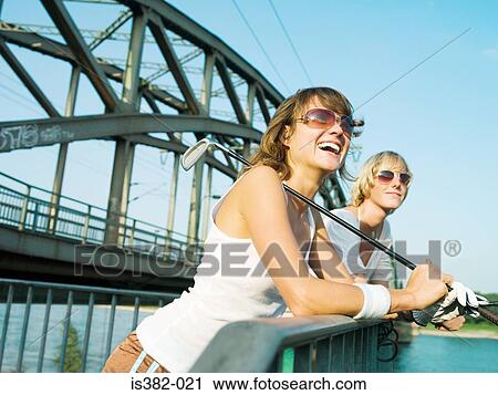 Female golfers by a bridge View Large Photo Image Stock Image - Female golfers by a bridge. Fotosearch