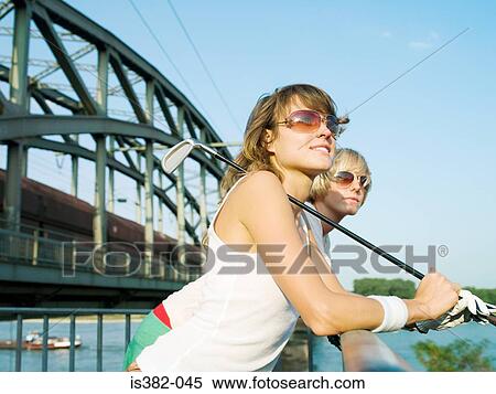 Female golfers by a bridge View Large Photo Image Stock Photography - Female golfers by a bridge. Fotosearch