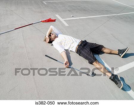 Golfer lying in car park View Large Photo Image Stock Image - Golfer lying in car park. Fotosearch