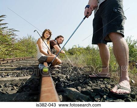 Golfers on railway tracks View Large Photo Image Stock Image - Golfers on railway tracks. Fotosearch