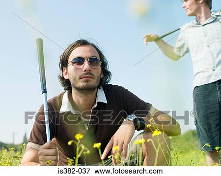 Male golfers in a field View Large Photo Image Stock Photo - Male golfers in a field. Fotosearch