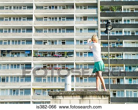 Urban golfer by apartment building View Large Photo Image Stock Photograph - Urban golfer by apartment building. Fotosearch