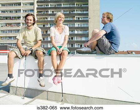 Urban golfers sitting on wall View Large Photo Image Stock Photography - Urban golfers sitting on wall. Fotosearch