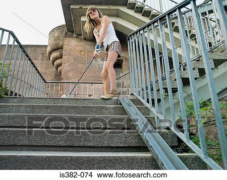 Woman playing golf on steps View Large Photo Image Picture - Woman playing golf on steps. Fotosearch