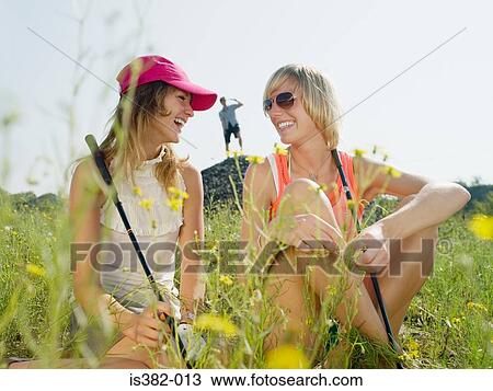Stock Image - Young female golfers laughing. Fotosearch