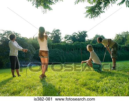 Young people playing golf in park View Large Photo Image Stock Image - Young people playing golf in park. Fotosearch