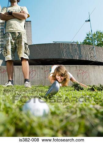 Young woman and man playing golf View Large Photo Image Stock Photo - Young woman and man playing golf. Fotosearch