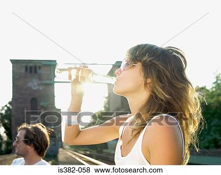 Young woman drinking View Large Photo Image Stock Photo - Young woman drinking. Fotosearch