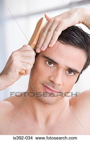 Man combing his hair View Large Photo Image Picture - Man combing his hair. Fotosearch