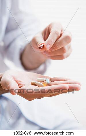 Stock Photograph - Man holding tablets. Fotosearch