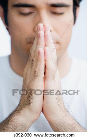Stock Image - Man praying. Fotosearch