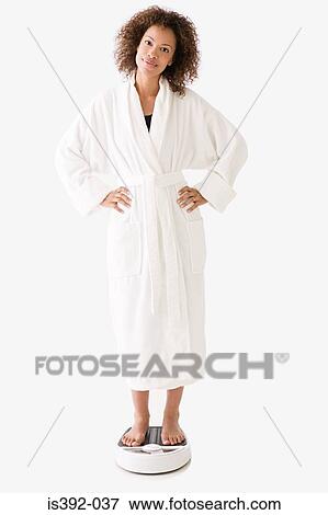 Woman standing on bathroom scales View Large Photo Image Stock Photo - Woman standing on bathroom scales. Fotosearch