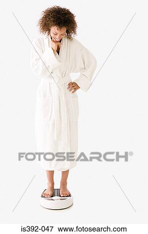 Woman standing on bathroom scales View Large Photo Image Stock Photo - Woman standing on bathroom scales. Fotosearch