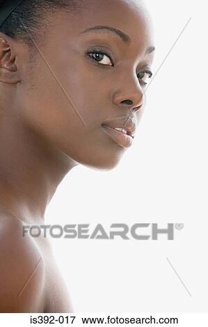 Stock Photo - Woman turning to look at camera. Fotosearch