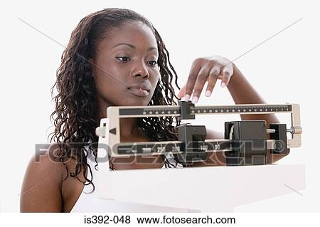 Woman weighing herself View Large Photo Image Stock Photo - Woman weighing herself. Fotosearch