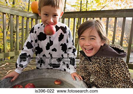 Boy and girl apple bobbing View Large Photo Image Stock Image - Boy and girl apple bobbing. Fotosearch