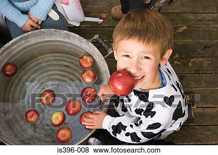 Boy apple bobbing View Large Photo Image Stock Photo - Boy apple bobbing. Fotosearch