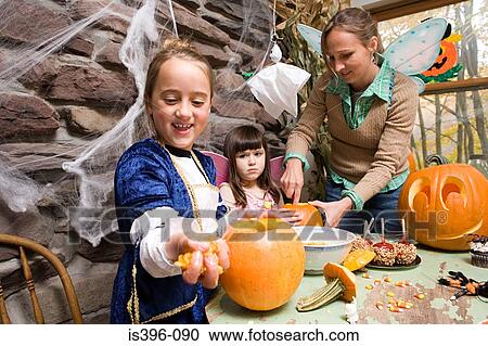 Stock Image - Carving pumpkins. Fotosearch
