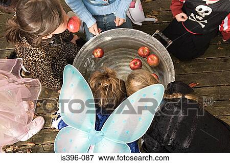 Children apple bobbing View Large Photo Image Stock Photo - Children apple bobbing. Fotosearch
