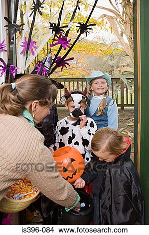 Picture - Children getting halloween treats. Fotosearch