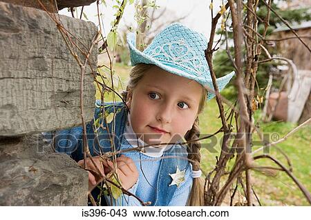 Cowgirl peering round corner View Large Photo Image Stock Image - Cowgirl peering round corner. Fotosearch