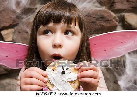 Girl holding a halloween cookie View Large Photo Image Stock Image - Girl holding a halloween cookie. Fotosearch