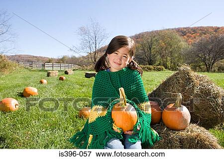Girl in field with pumpkins View Large Photo Image Stock Photo - Girl in field with pumpkins. Fotosearch
