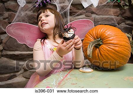 Girl with a spider cake View Large Photo Image Stock Image - Girl with a spider cake. Fotosearch