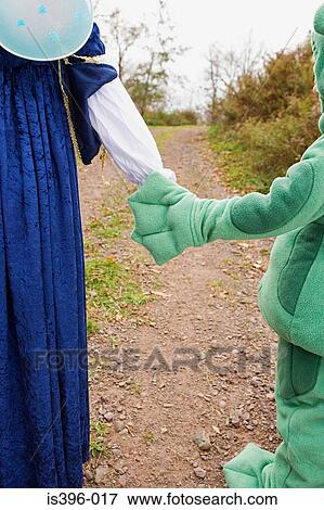 Kids in costume holding hands View Large Photo Image Stock Photo - Kids in costume holding hands. Fotosearch