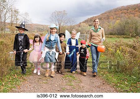 Woman and children trick or treating View Large Photo Image Stock Image - Woman and children trick or treating. Fotosearch