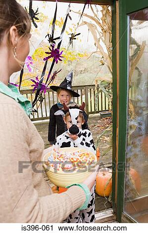 Woman with sweets for trick or treaters View Large Photo Image Stock Image - Woman with sweets for trick or treaters. Fotosearch