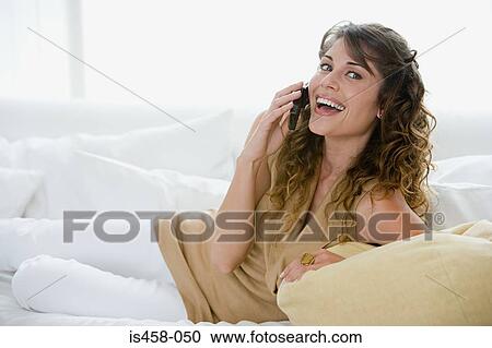 Stock Image - Woman using cell phone. Fotosearch