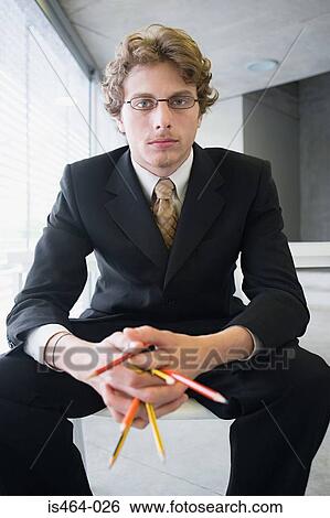 Businessman holding pencils View Large Photo Image Stock Photograph - Businessman holding pencils. Fotosearch