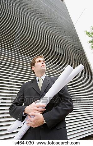 Businessman with blueprints View Large Photo Image Stock Image - Businessman with blueprints. Fotosearch