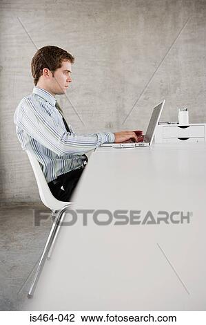 Man working on laptop View Large Photo Image Stock Image - Man working on laptop. Fotosearch