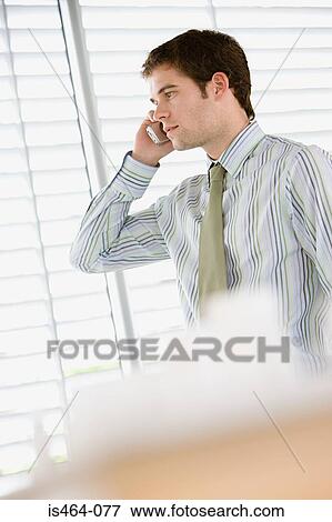 Stock Photo - Office worker on cellphone. Fotosearch
