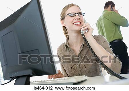 Woman on telephone in an office View Large Photo Image Stock Image - Woman on telephone in an office . Fotosearch