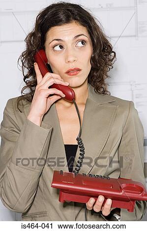 Stock Image - Woman using telephone. Fotosearch