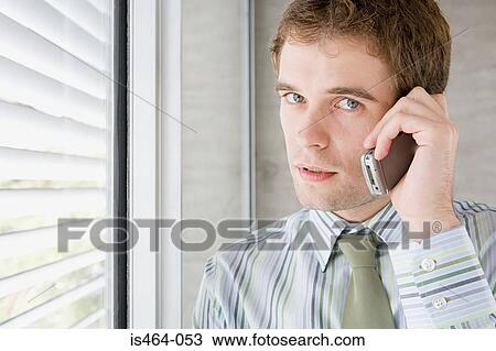 Stock Image - Young man on cellphone. Fotosearch