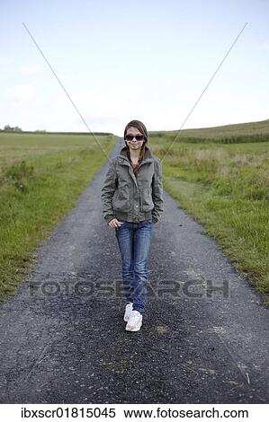 13-year-old girl in a stylish outfit with pink sunglasses on a secluded gravel road in a rural setting View Large Photo Image Stock Photography - 13-year-old girl in a stylish outfit with pink sunglasses on a secluded gravel road in a rural setting. Fotosearch