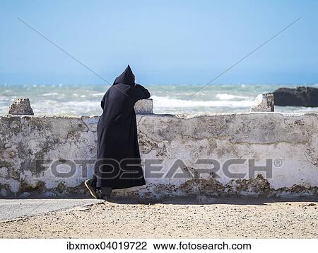 "A Berber with black djellaba leaning against the harbor wall, Place Moulay Hassan, Essaouira, Morocco, Africa" View Large Photo Image Stock Image - "A Berber with black djellaba leaning against the harbor wall, Place Moulay Hassan, Essaouira, Morocco, Africa". Fotosearch