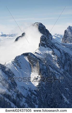 Stock Photography - "A cloud hanging next to Staubernkanzel mountain, 1860m, Kreuzberge mountains at the back, canton of Appenzell Innerrhoden, Switzerland, Europe". Fotosearch
