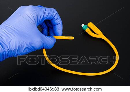 A hand with a blue medical glove is holding a balloon catheter View Large Photo Image Stock Image - A hand with a blue medical glove is holding a balloon catheter. Fotosearch